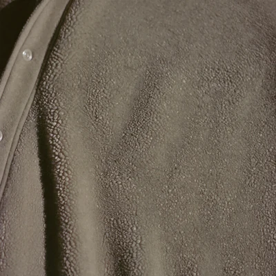 Macro detail of the deep pile of a faded fleece pullover.